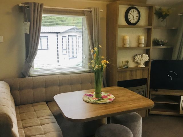 A dining area with a table and sofa at 38 The Green