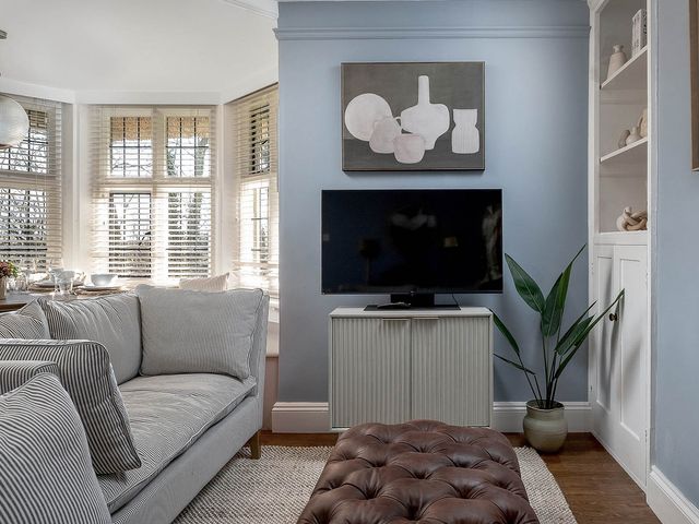 A living room with a sofa and television at East Lodge in Peterborough