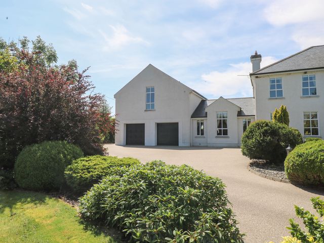 A house with a garage and garden at The East Wing Apartment in Claremorris