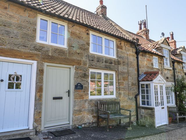 The exterior of Rigg Cottage with a door and windows in Sandsend