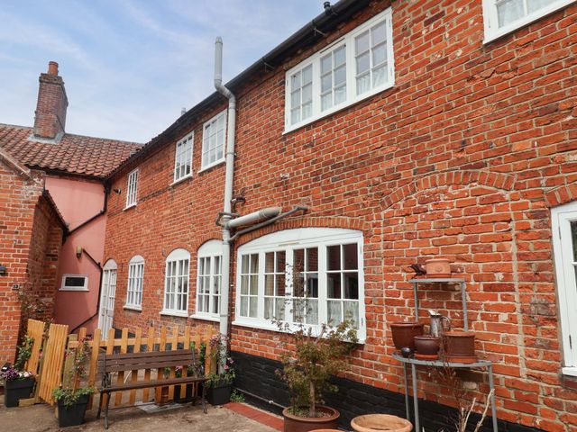 An outdoor area with a brick wall and a wooden fence at 11 Ballygate in Babbacombe