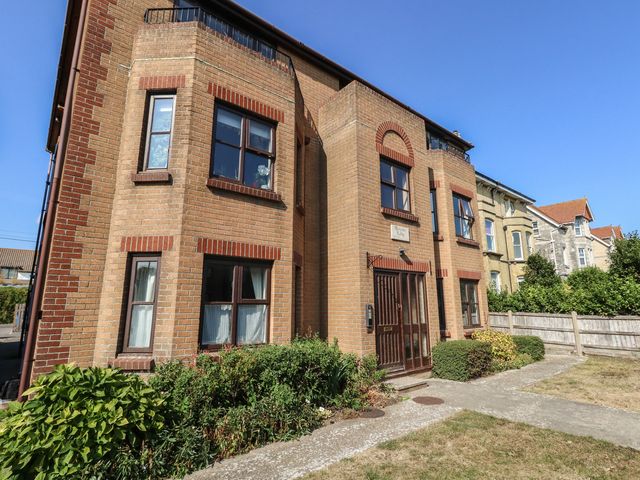 A brick building with windows and a front door at Flat 9 in Swanage