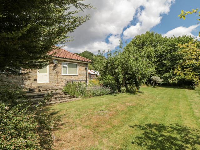 A house with garden and trees at Low Muffles Bridge