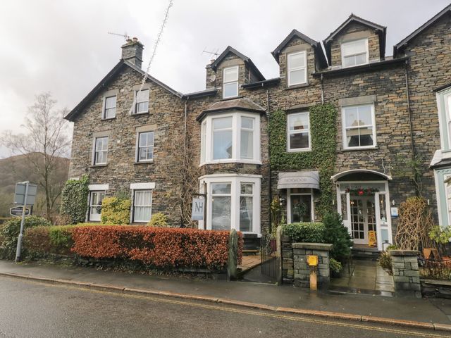 A building with ivy and sign at Norwood House in Ambleside
