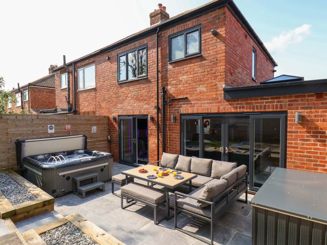 A garden with a hot tub and seating area at 12 Hunley Avenue Brotton near Saltburn-By-The-Sea
