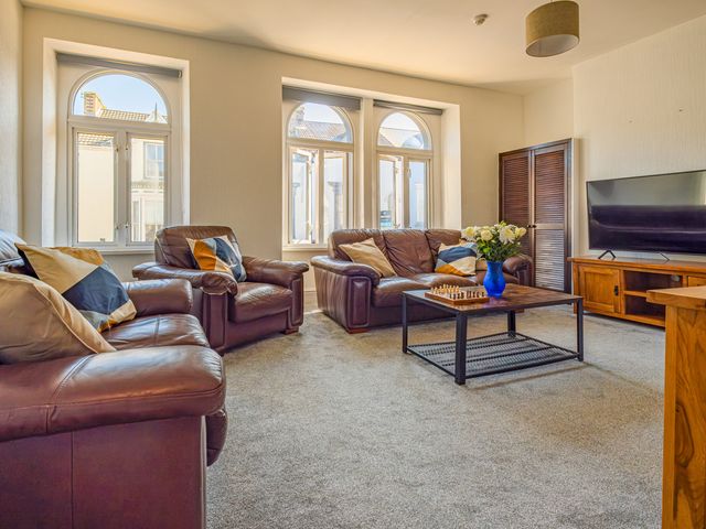 A living room with a sofa and coffee table at Flat 56 Newton Road Abertawe