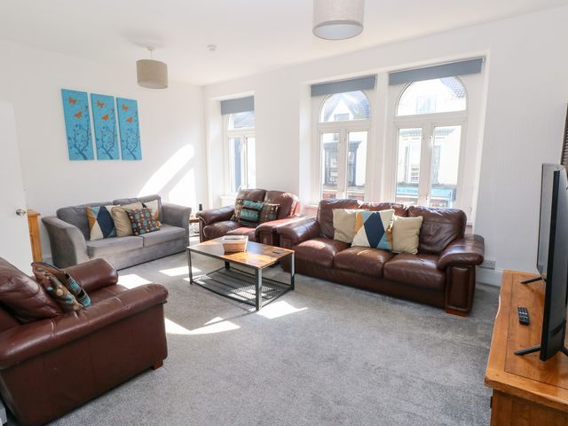 A living room with sofas and a coffee table at Castleview Coastal Comfort in Mumbles