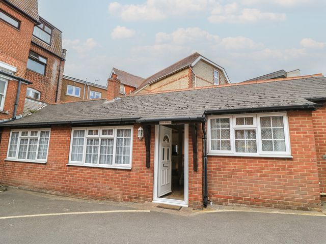 A brick building with a front door and windows at Claire Cottage in Swanage