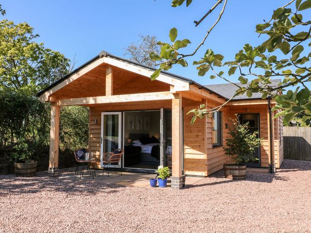 A house with a porch and garden furniture at The Lodge at Middleton House Stoke-on-Trent