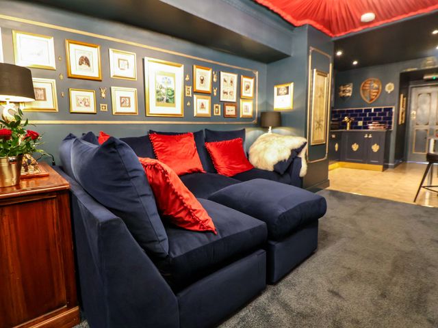 A living room with a sofa and decorative frames at The Hollow in Holywell