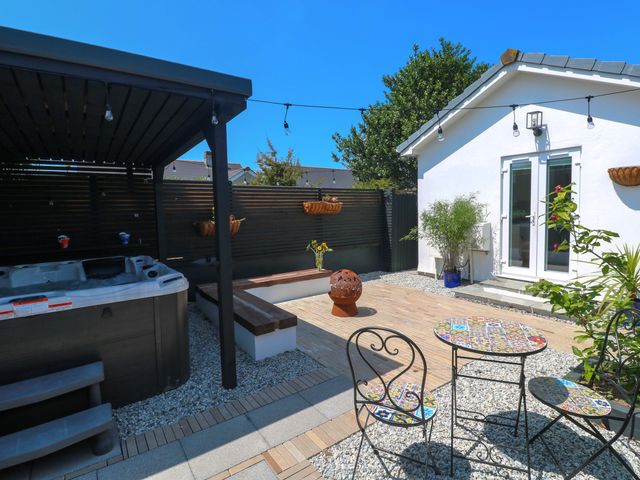 A garden with a hot tub and seating area at Carn Brea in Redruth