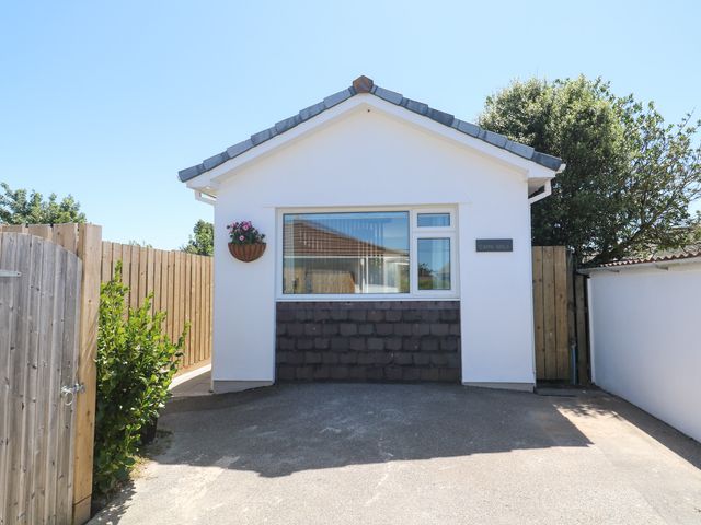 A house with a front entrance and wooden fence at Carn Brea in Redruth
