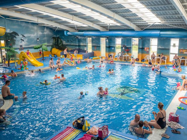 A swimming pool with water slides and families enjoying at Skylight Stargazer - Billing Aquadrome