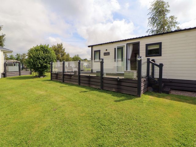 An outdoor area with a holiday home and landscaping at 22 Yealand in Carnforth