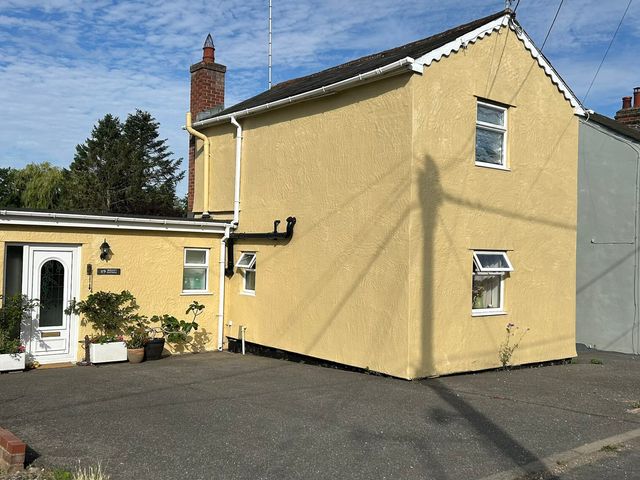 A house with a door and windows at Berkley Cottage in Coggeshall