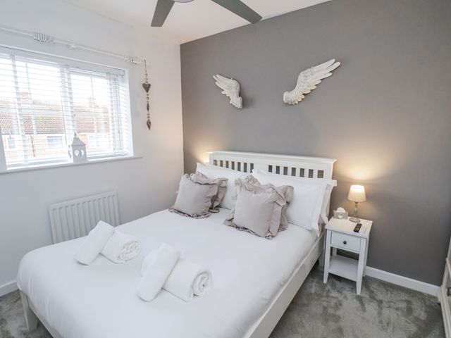 A bedroom with a double bed and bedside table at Pearl Stone House in Whitby