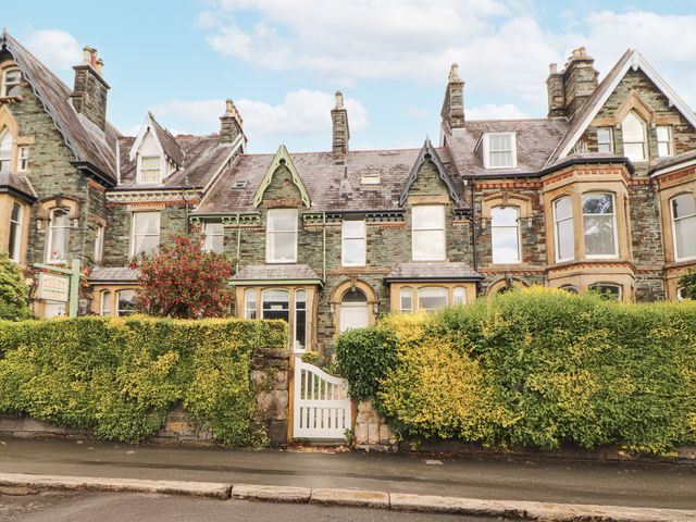 A building with windows and doors surrounded by a hedge at 43 Station Road in Keswick