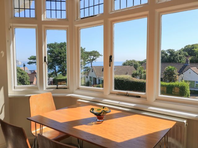 A dining room with a table and chairs at Purbeck Vista in Swanage