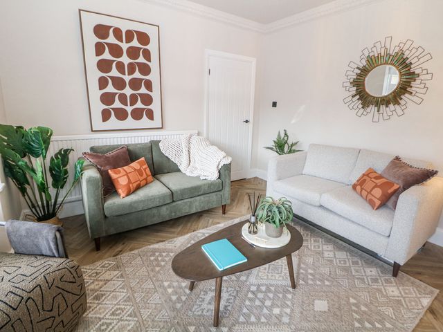A living room with sofas and a coffee table at 37 Berry Hill Lane in Mansfield