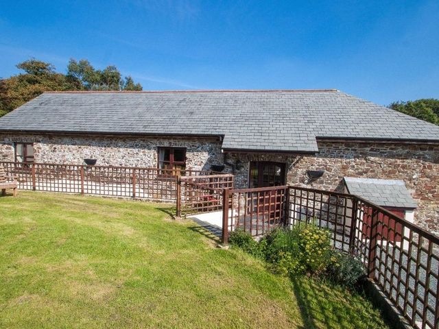 A stone house with garden and fence at Billy's Barn in Bradworthy