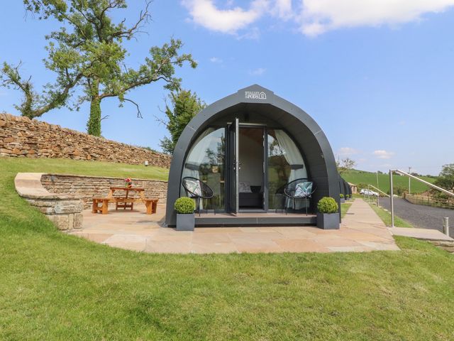 A glamping pod with outdoor seating at Pendle in Nelson