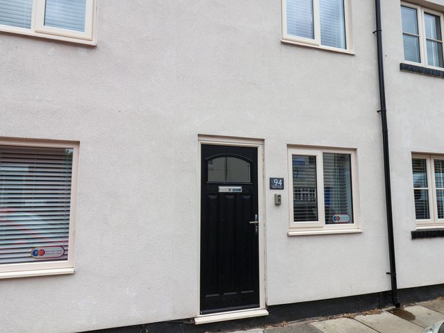 Front of a house featuring a black door and windows at 94 Church Street in Guisborough