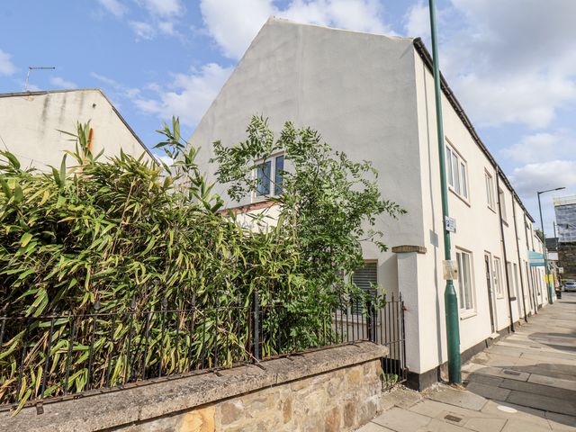 A building with bushes and a sidewalk at 96 Church Street in Guisborough