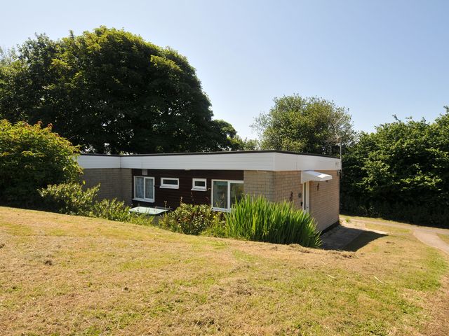 A house with windows and greenery at 8 Hillside Bude