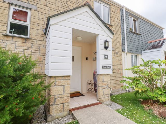 An entrance with a door and plant at Trouts Reach in Falmouth