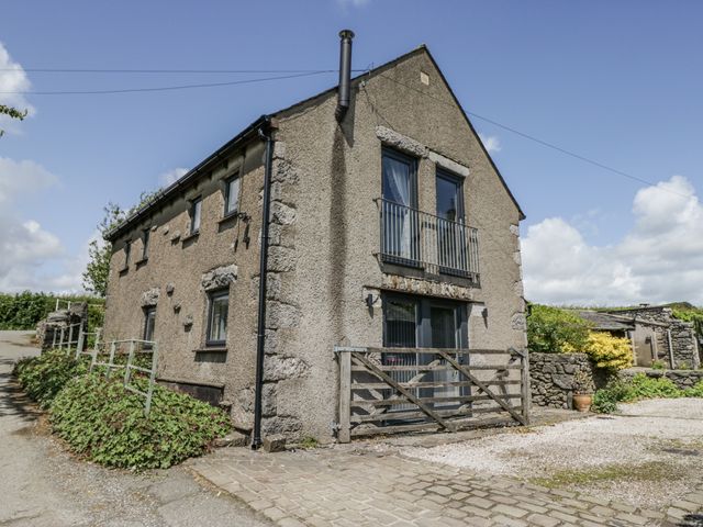 A house with a balcony and driveway at Threagill in Carnforth