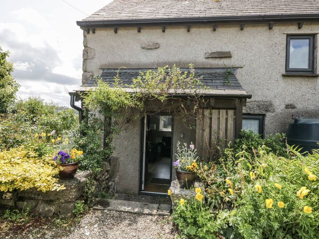 An entryway with plants and flowers at Threagill in Carnforth