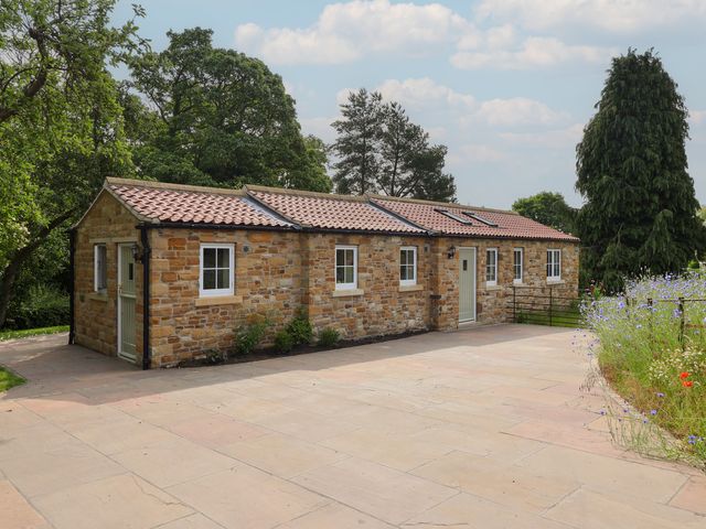 A stone building with windows and a door at Apple Tree Cottage in York