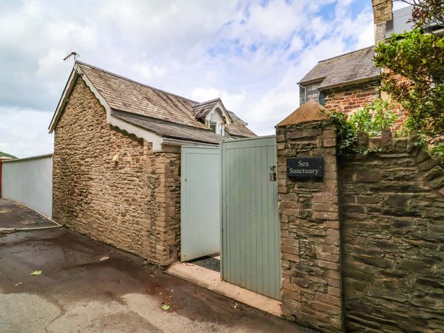 An entrance with a gate and stone wall at Sea Sanctuary