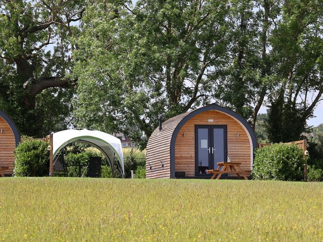 A wooden cabin and a tent in an outdoor area at Honeypot Hideaways - Manuka