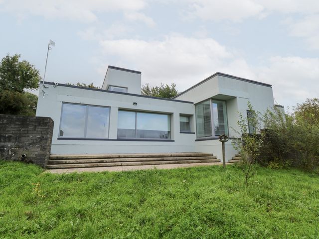 A house with large windows and steps in a garden at The Cottage in Ballinagleira
