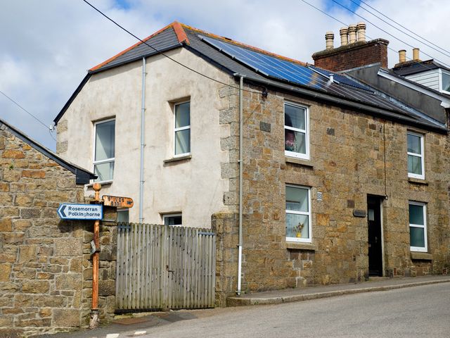 A house with solar panels and a signpost at Chyandaunce in Gulval