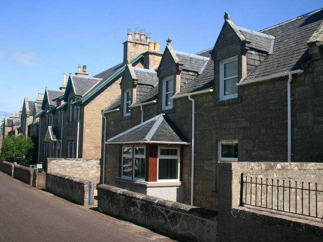 Houses with stone facades and pitched roofs at 2 Links Place Nairn