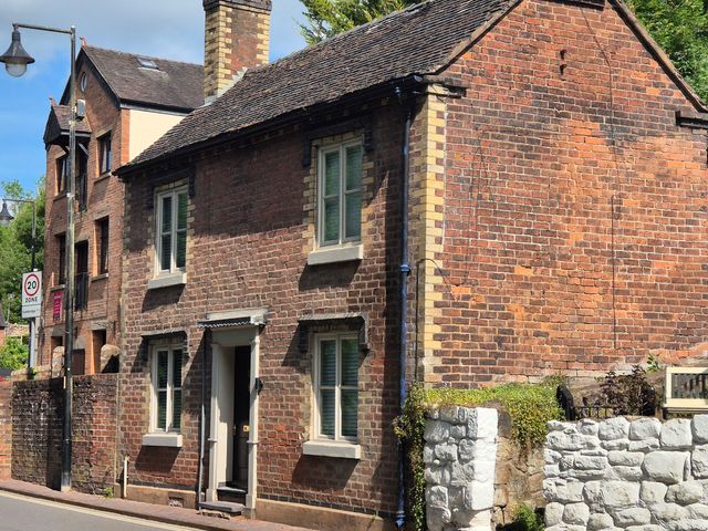 A brick house with a front door and windows at 18 The Wharfage Ironbridge