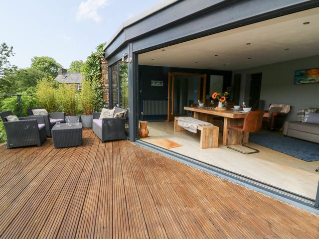 An outdoor deck with seating and a dining area at The Old Barn in Ciliau Aeron near Aberaeron