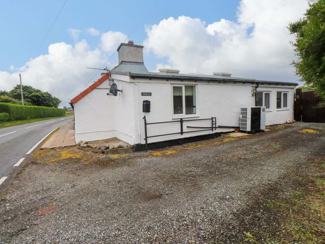 A house with windows and an air conditioning unit at 2 Llainwen Ty Croes
