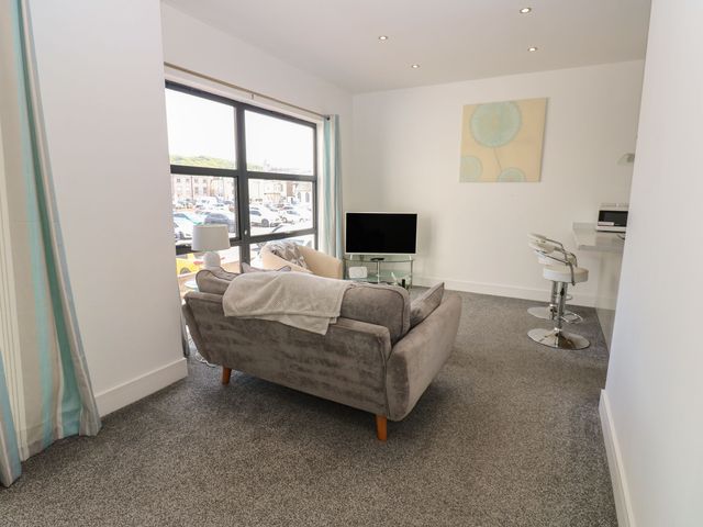 A living room with a sofa and television at Harbour View in Whitehaven