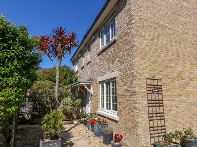 A house with plants and flower pots at Fairways House in Weymouth