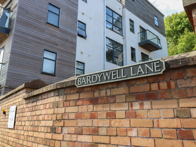 A street sign for Bardywell Lane in front of a building in Whitehaven