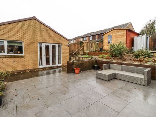 A garden with a paved patio and outdoor furniture at 26 Blakelaw Court Alnwick