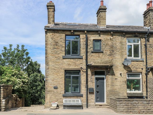 A house with a front door and several windows at Myrtle Nook in Keighley