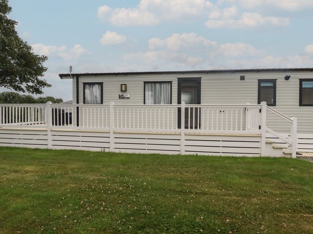 A mobile home with a deck and railing at The Maples, no. 56 Hewas Water near Polgooth