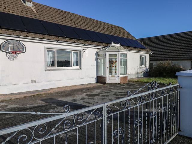 A house with solar panels and a basketball hoop at Maes Hyfryd in Efailwen near Maenclochog