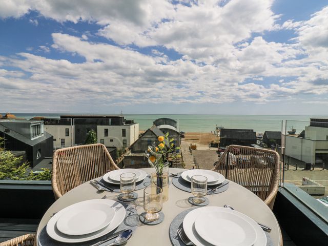 An outdoor dining area with a view of the beach at Flat 4 in Hythe