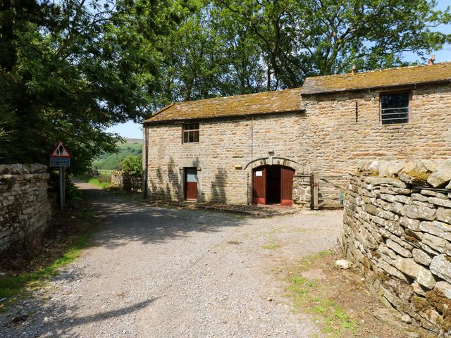 A stone building with doors and windows at West Barn in 