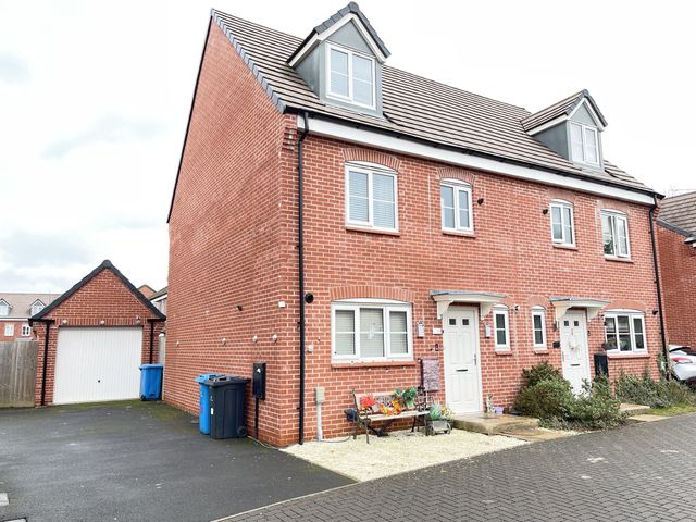 A house with a driveway and garage at Derby Den in Breadsall near Derby